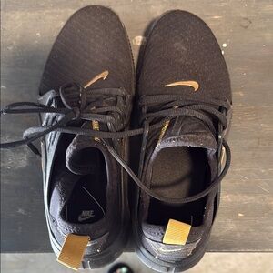 Nike Black and Gold Athletic Shoes with Modern Design